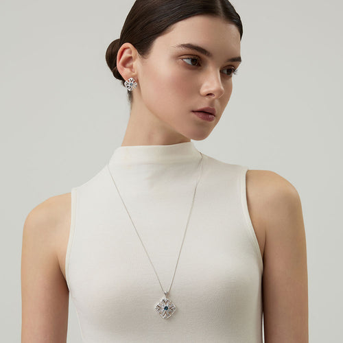 Side view of model wearing TIKOO original design blue gemstone necklace and matching stud earrings.
