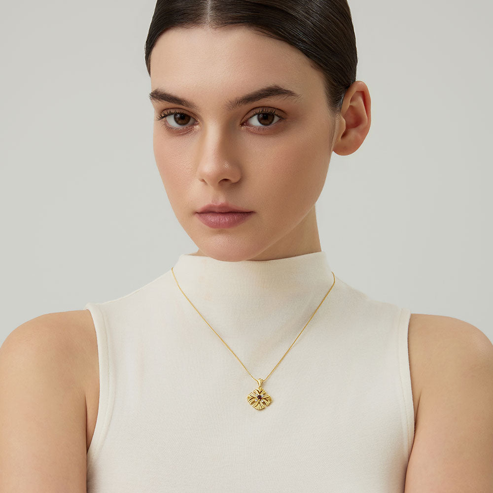 Model wearing the TIKOO natural garnet pendant to show the vibrant red color and elegant scale of the jewelry.