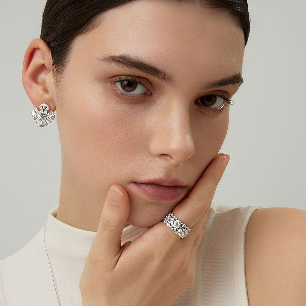 Close-up of model with TIKOO floral ring and matching silver-tone earrings for a coordinated look.
