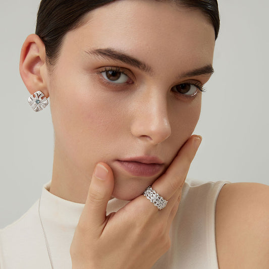 Close-up of model with TIKOO floral ring and matching silver-tone earrings for a coordinated look.