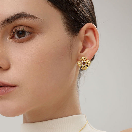 A model wearing the TIKOO natural garnet floral studs to show the elegant scale and vibrant red color.