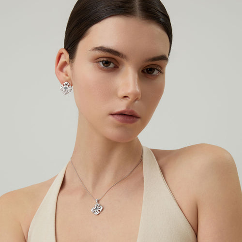 A model wearing TIKOO natural topaz earrings to show the vibrant sky-blue color and elegant scale.