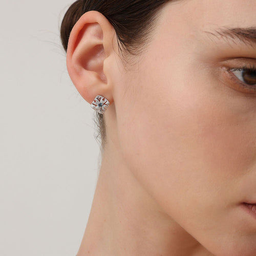 Close-up of TIKOO blue gemstone earrings on a model, showcasing the diamond-like sparkle of VVS Moissanite.