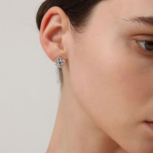 Close-up of TIKOO blue gemstone earrings on a model, showcasing the diamond-like sparkle of VVS Moissanite.