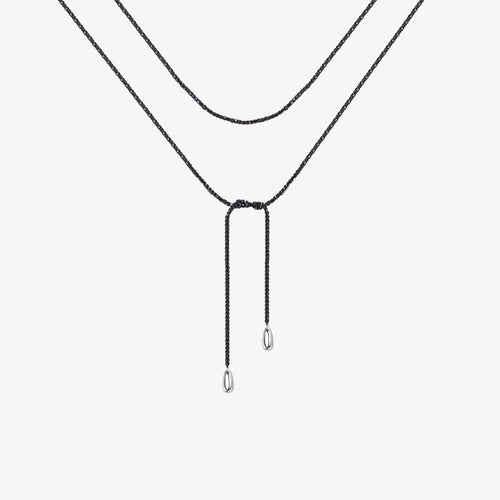 TIKOO original natural black spinel beaded lariat necklace with thick white gold plating and small drop pendants on a clean white background.