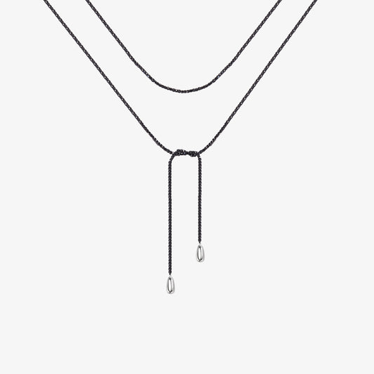 TIKOO original natural black spinel beaded lariat necklace with thick white gold plating and small drop pendants on a clean white background.