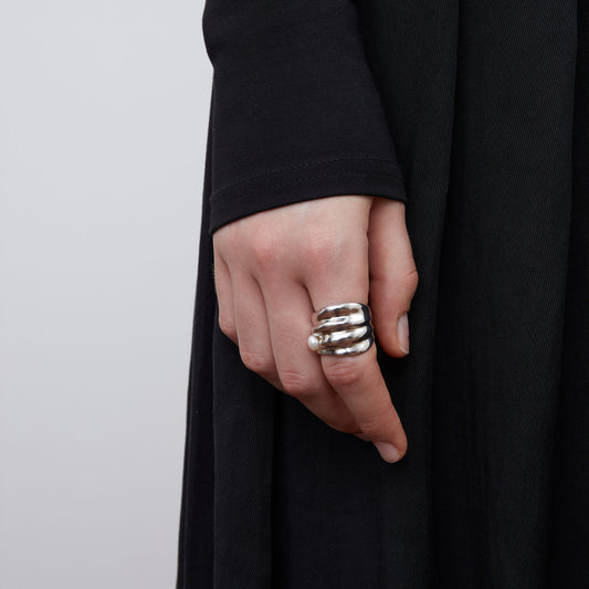 Close-up of a model wearing TIKOO bold irregular silver-tone ring with a small white pearl.