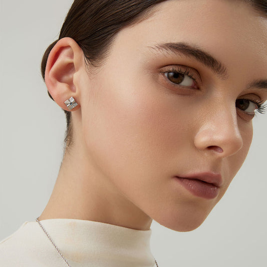 Side view of a woman styled with TIKOO architectural blue topaz studs and elegant updo.